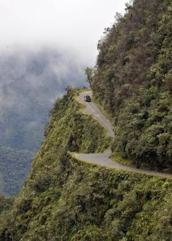 A car drives on the "death road" --one of the world most dangerous-- along a steep ravine near Challa, Los Yungas region, 110 km north of La Paz, on February 9, 2012. The 400km-long road linking La Paz with Los Yungas, with stretches as high as 4,000 metre (13,100 feet) of altitude,  is so dangerous that is popularly known as "death road".   AFP PHOTO/Aizar Raldes (Photo credit should read AIZAR RALDES/AFP/Getty Images)