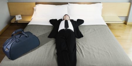 Businessman napping on the bed