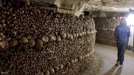 People visit the Catacombs of Paris which hold over six million skulls and bones. These underground quarries were used to store the remains of generations of Parisians in a bid to cope with the overcrowding of Paris' cemeteries at the end of the 18th century, and are now a popular tourist attraction. AFP PHOTO/DOMINIQUE FAGET (Photo credit should read DOMINIQUE FAGET/AFP/Getty Images)