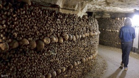 People visit the Catacombs of Paris which hold over six million skulls and bones. These underground quarries were used to store the remains of generations of Parisians in a bid to cope with the overcrowding of Paris' cemeteries at the end of the 18th century, and are now a popular tourist attraction. AFP PHOTO/DOMINIQUE FAGET        (Photo credit should read DOMINIQUE FAGET/AFP/Getty Images)