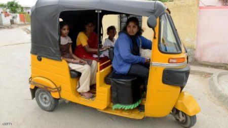 Indian auto rickshaw driver Vennapusa Narayanamma drives passengers in her vehicle in the Nijampet District on the outskirts of Hyderabad on August 3, 2014. Thirty six year old Narayanamma, who earns between Indian Rupees 300-400 (USD 4.90-6.55) per day,  is an un-educated, mother of two children, She has been driving  her vehicle which she purchased with the assistance of an NGO for the last five years, and it provides a means to supplement her family income as well as a safe mode of transport for the working  women of her community.   AFP PHOTO/NOAH SEELAM        (Photo credit should read NOAH SEELAM/AFP/Getty Images)