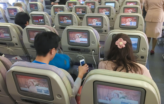 MUNICH, GERMANY - DECEMBER 04: Flight passengers with mobile phone use entertainment program on screens on board of a Airbus A 380 on the way to Myanmar via Dubai at Munich Airport on December 04, 2016 in Munich, Germany. (Photo by EyesWideOpen/Getty Images)